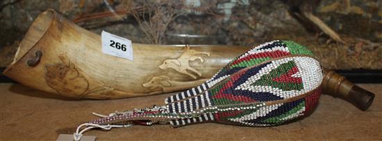 Cow horn carved with dogs and a sloth and a Kenyan beadwork flask